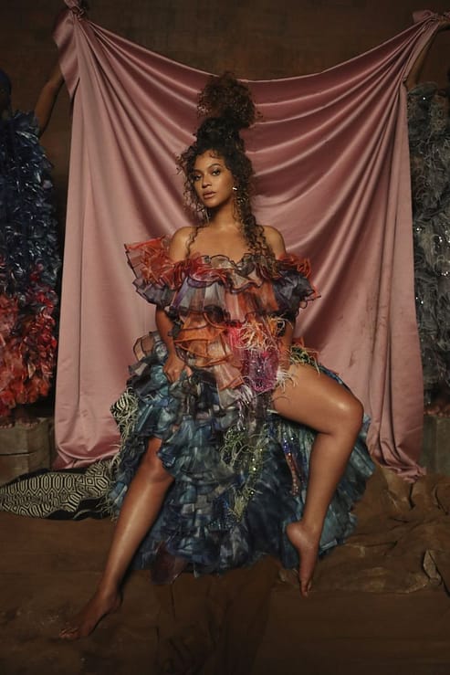 Beyoncé wears an off-the-shoulder, frilly dress by Mary Katrantzou in Black is King.